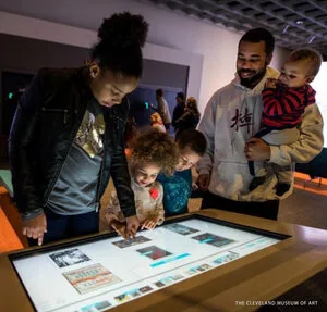 Family using an interactive touch table in ArtLens Gallery, The Cleveland Museum of Art