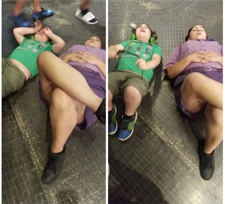Universal's Islands of Adventure employee lying on the floor beside a boy with autism to comfort him