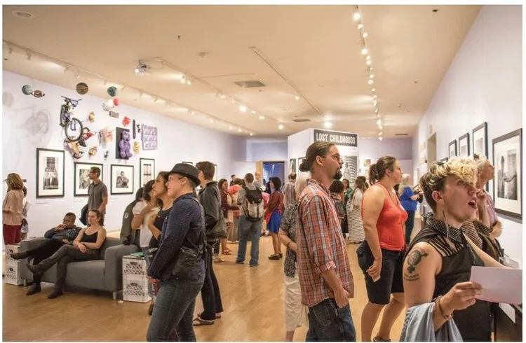 Crowd exploring a gallery exhibit at the Santa Cruz Museum of Art and History