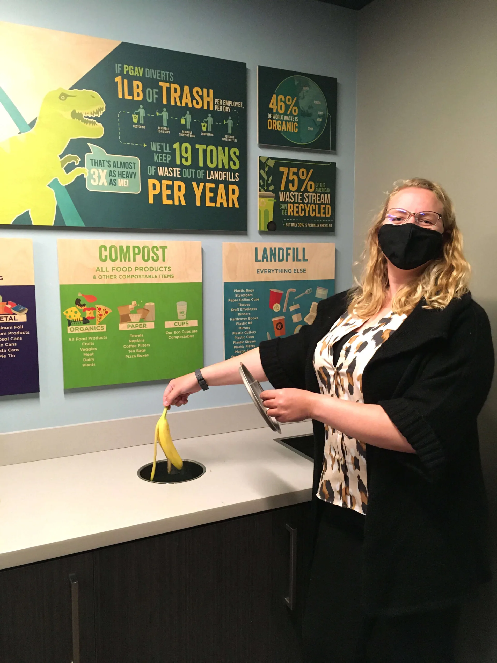 PGAV staff member in a mask dropping a banana peel into the compost bin at the office waste sorting station