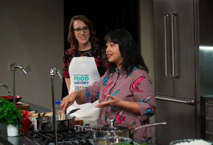 Two presenters in aprons leading a live cooking demonstration at the National Museum of American History
