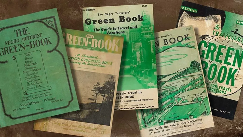 Vintage editions of The Negro Motorist Green Book travel guides spread on a table