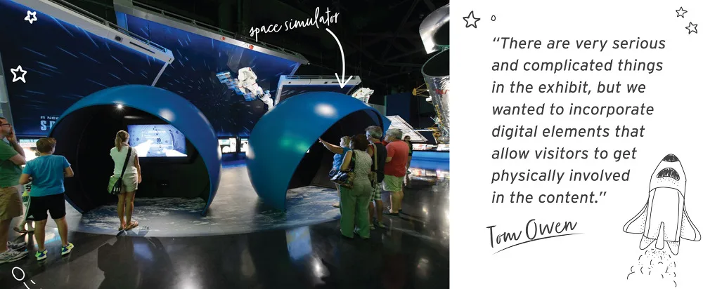 Visitors at space simulator domes in the Atlantis exhibit, beside a Tom Owen quote on physical, digital interactives