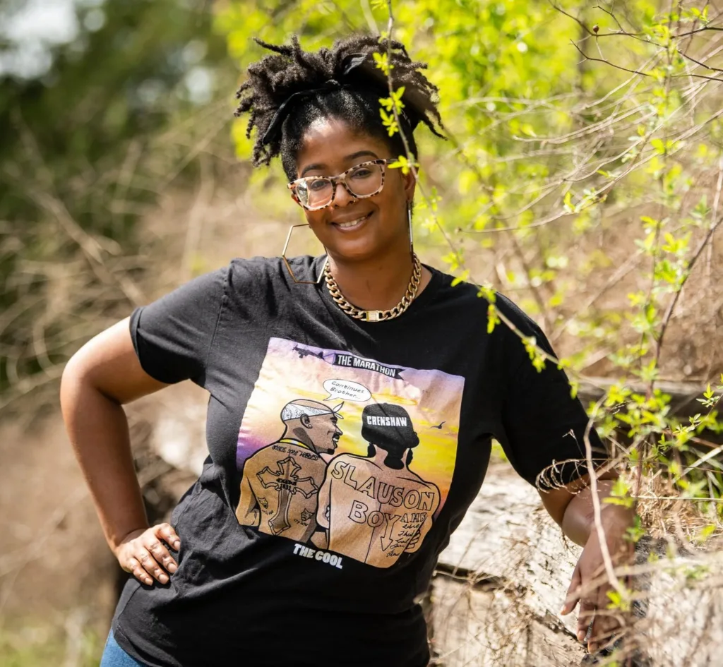 Brigette Jones smiling outdoors among spring branches