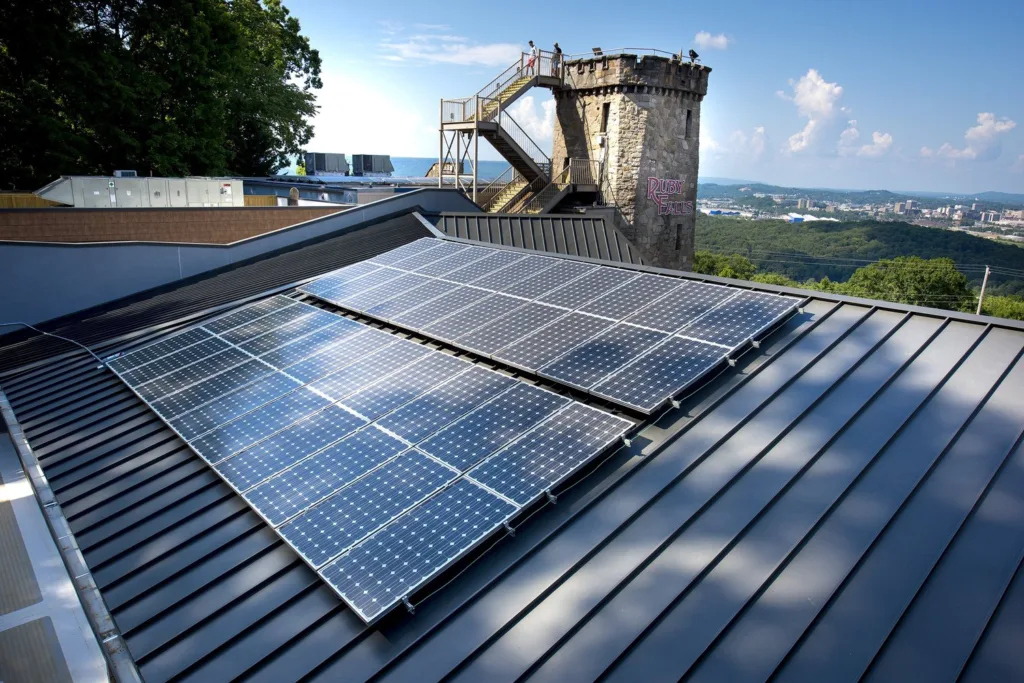 Rooftop solar panels at Ruby Falls with the castle-style tower and Chattanooga views behind