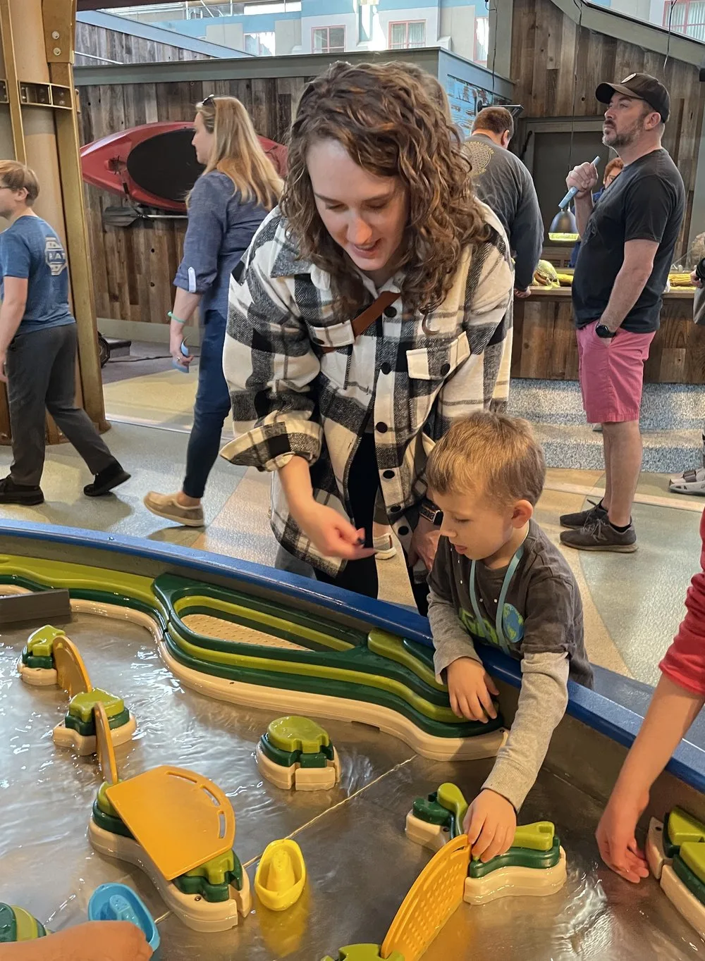 Allison and her nephew playing at a water table at St. Louis Aquarium
