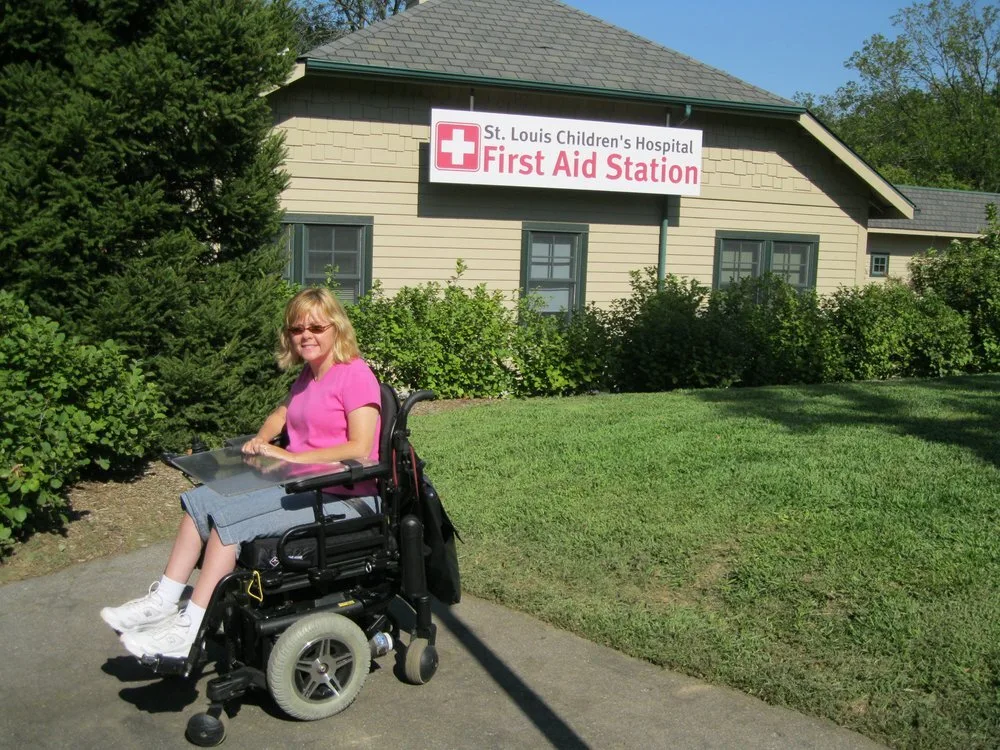 Katie Rodriguez Banister in her wheelchair outside the St. Louis Children's Hospital First Aid Station at the St. Louis Zoo