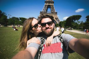 Stock footage of a couple at the Eiffel Tower for "Generationally Speaking" Destinology