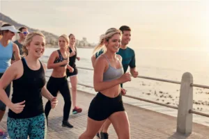 Image from February 2018 Destinology, the Fight for Attendance, of people running along the beach.