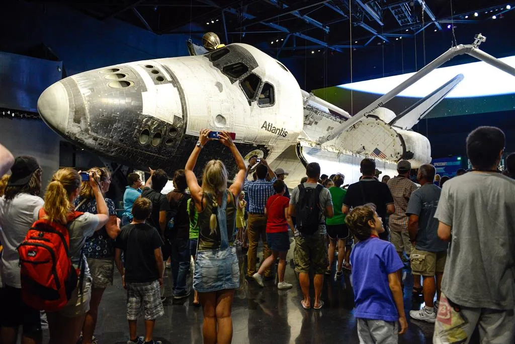 Guests photographing Space Shuttle Atlantis on display at Kennedy Space Center Visitor Complex