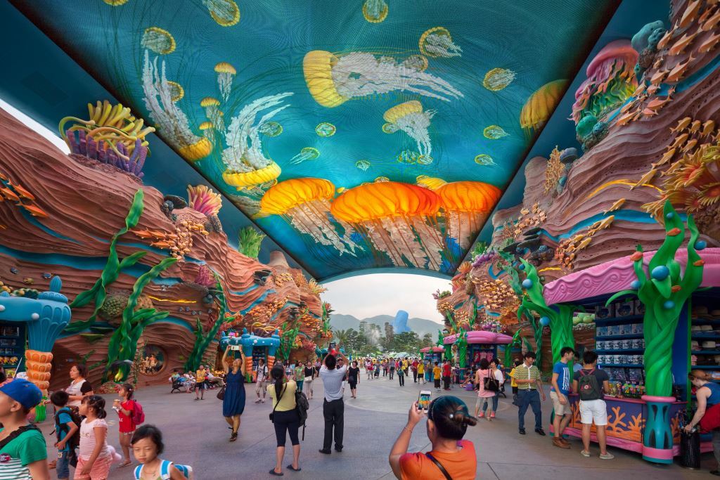 The entry to Chimelong Ocean Kingdom, featuring a digital ceiling and massive coral with a pink border