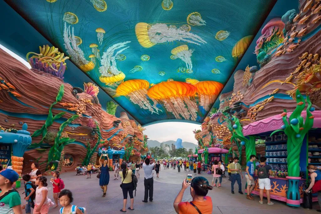 The entry to Chimelong Ocean Kingdom, featuring a digital ceiling and massive coral with a pink border