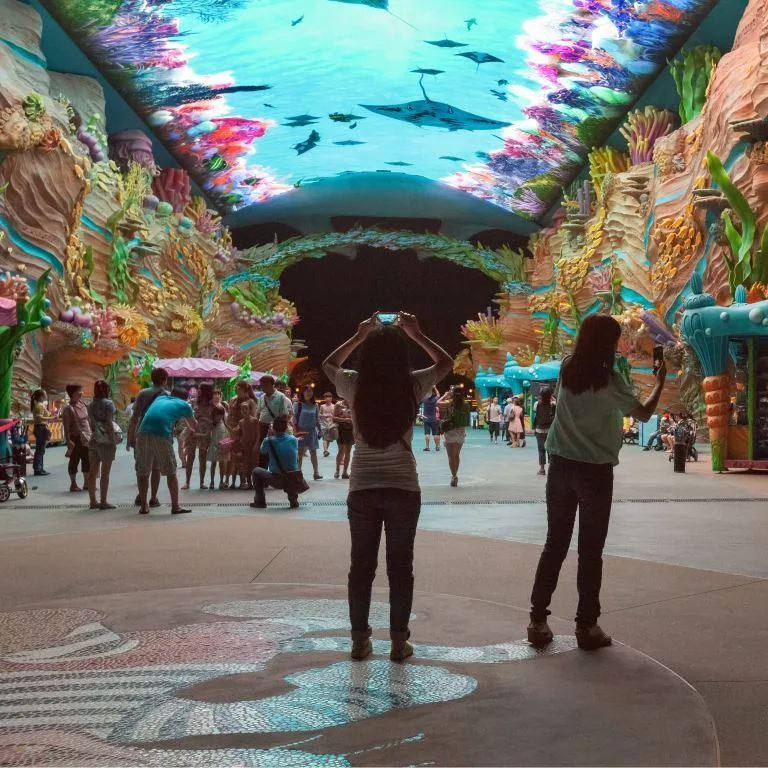 The evening entry to Chimelong Ocean Kingdom, featuring a digital ceiling and massive coral with a pink border