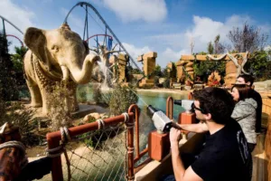 Guests spray an elephant statue during the floating attraction Angkor: Adventure in the Lost Kingdom at PortAventura