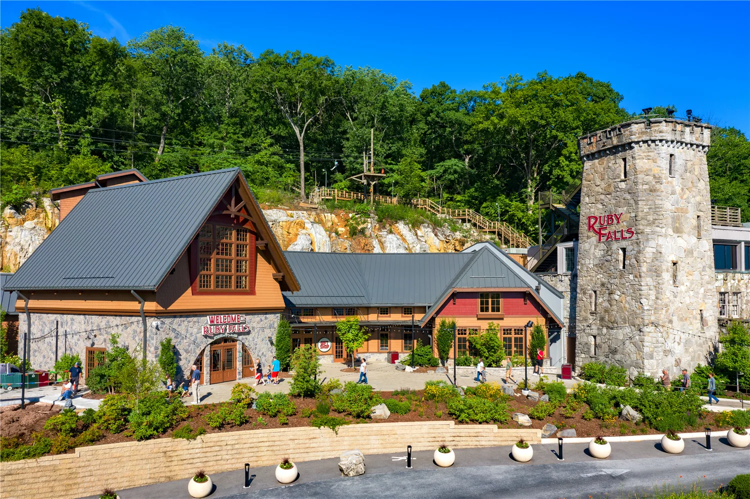 Ruby Falls expansion with its gabled welcome center, landscaped grounds and the stone castle tower on Lookout Mountain