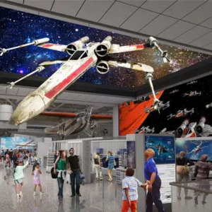 Rendering of an X-wing starfighter suspended over a busy exhibit hall with a starfield ceiling