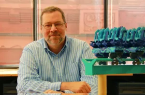 PGAV's Vice President Jeff Havlik poses with a roller coaster model