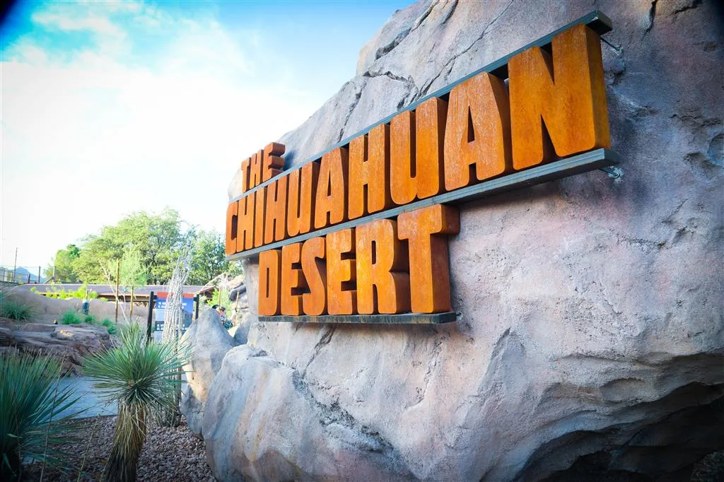 Chihuahuan Desert sign in rust-colored letters on themed rockwork at the El Paso Zoo entrance