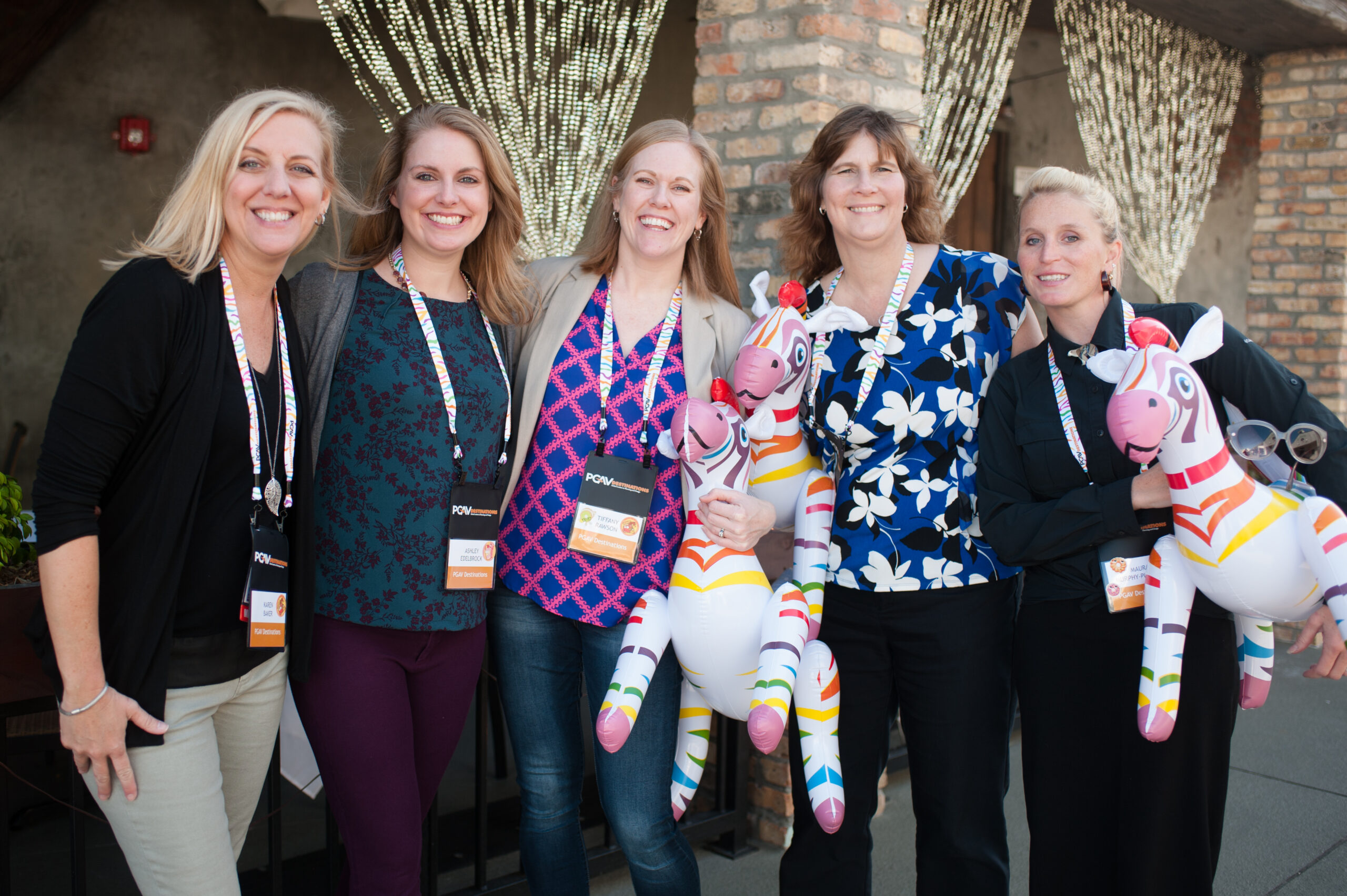 PGAV Destinations Karen Baker, Ashley Edelbrock, Tiffany Rawson, Marie Shellenberg, and Maura Pusateri pose with Spot the Zebra at the PGAV Pancake Breakfast at IAAPA 2017