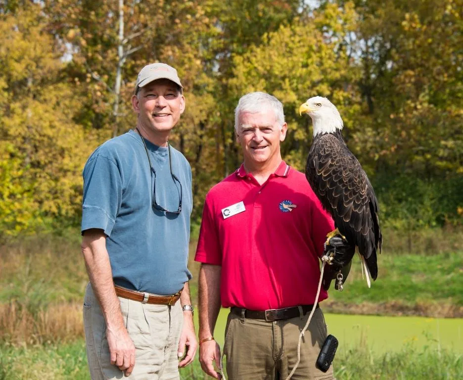 PGAV's Vice President John Kemper and World Bird Sanctuary chair poses with a bald eagle