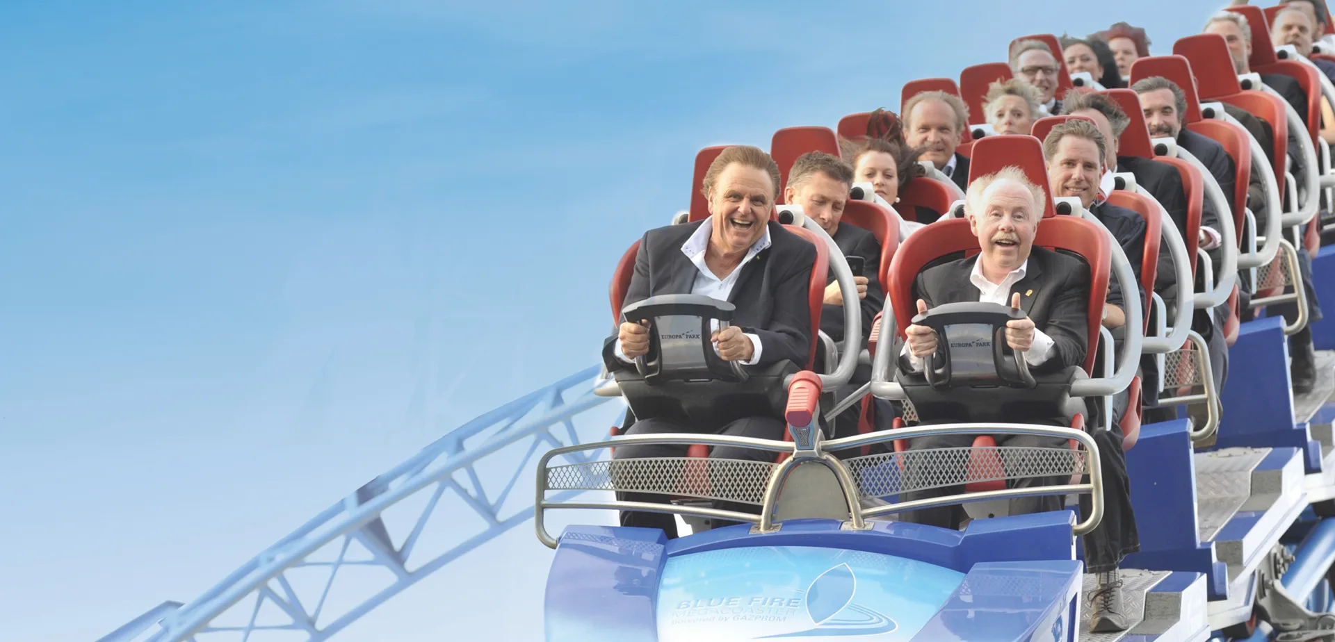 Business leaders in suits laughing as they ride a roller coaster, header art for Destinology Lessons in Leadership