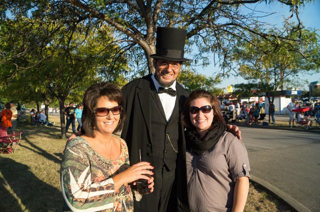 An Abraham Lincoln impersonator poses with guests at Looking for Lincoln