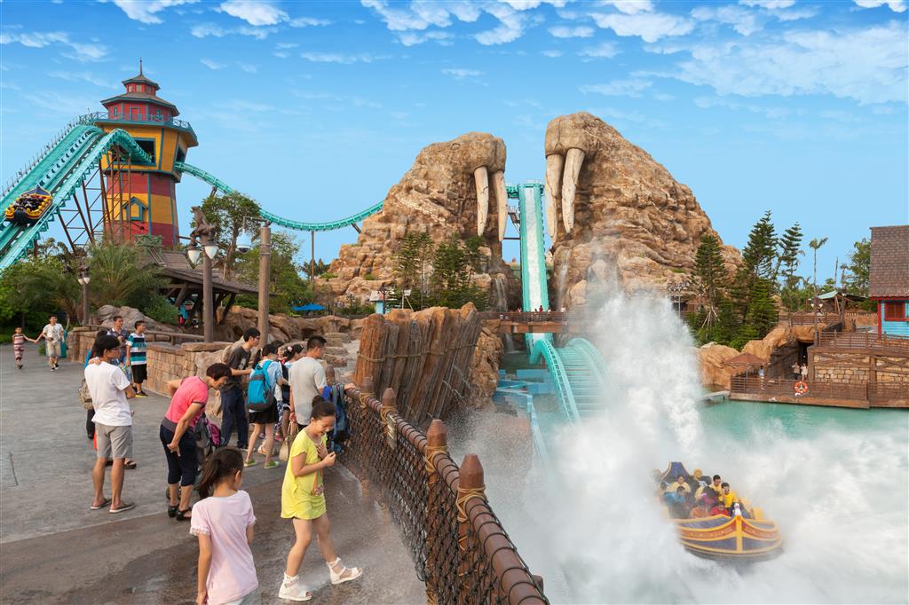 Guests ride the water coaster and splash nearby viewers at the Walrus Roller Coaster at Chimelong Ocean Kingdom
