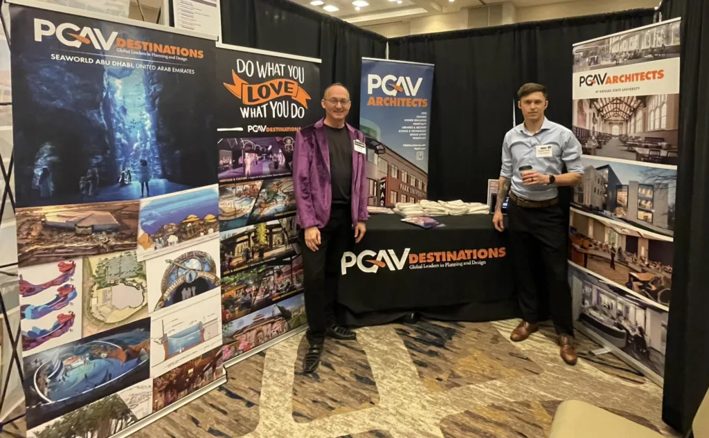 Two PGAV team members at the PGAV Destinations and PGAV Architects booth at a university career fair