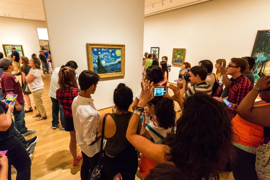Crowd of visitors photographing Van Gogh's The Starry Night at the Museum of Modern Art in New York