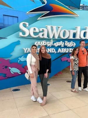 PGAV team members posing in front of the SeaWorld Yas Island, Abu Dhabi entrance sign