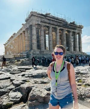 Woman in sunglasses posing in front of the Parthenon on the Acropolis in Athens