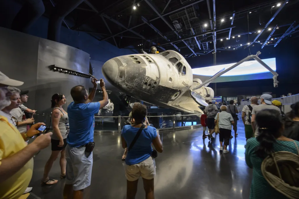Visitors photographing Space Shuttle Atlantis on display with its payload bay doors open at Kennedy Space Center Visitor Complex