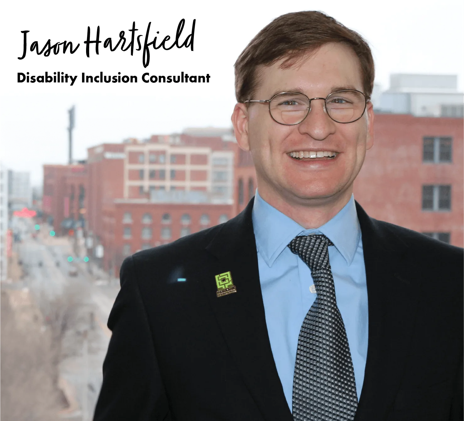 Headshot of Jason Hartsfield, Disability Inclusion Consultant, with a city street behind him