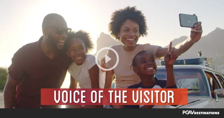 Voice of the Visitor video thumbnail showing a family taking a selfie outdoors at sunset