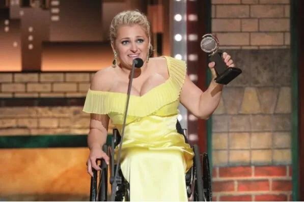 Actress in a wheelchair holding a Tony Award while giving her acceptance speech