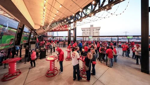 Fans mingling around high-top tables on the Budweiser Terrace at Busch Stadium