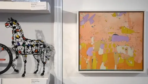 Wire horse sculpture and abstract painting on display in a loft gallery on the Asheville Art Museum's Urban Loft and Art Tour