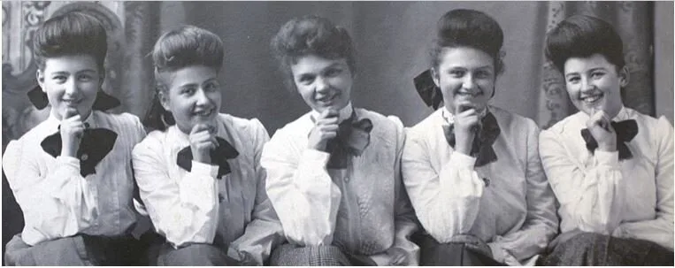 Historical photo of five Harvey Girls in white blouses posing with chins on hands, 1890s