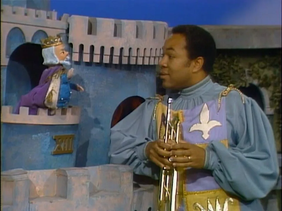King Friday XIII puppet at his castle in Mister Rogers' Neighborhood of Make-Believe, beside a costumed performer