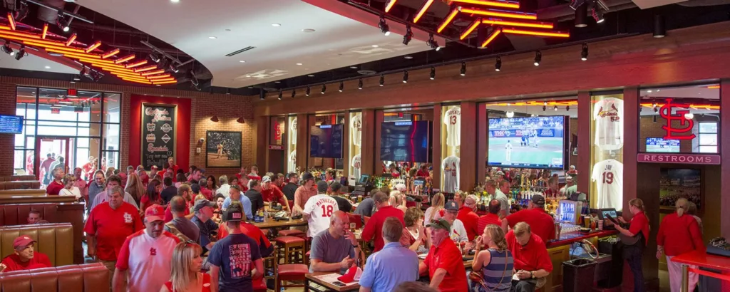 Crowded Cardinals Nation restaurant and bar with TVs and memorabilia at Ballpark Village