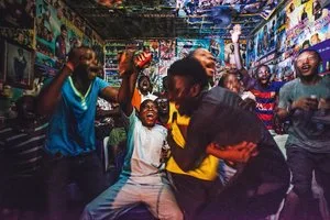 Crowd of young people dancing in a colorful graffiti-covered club