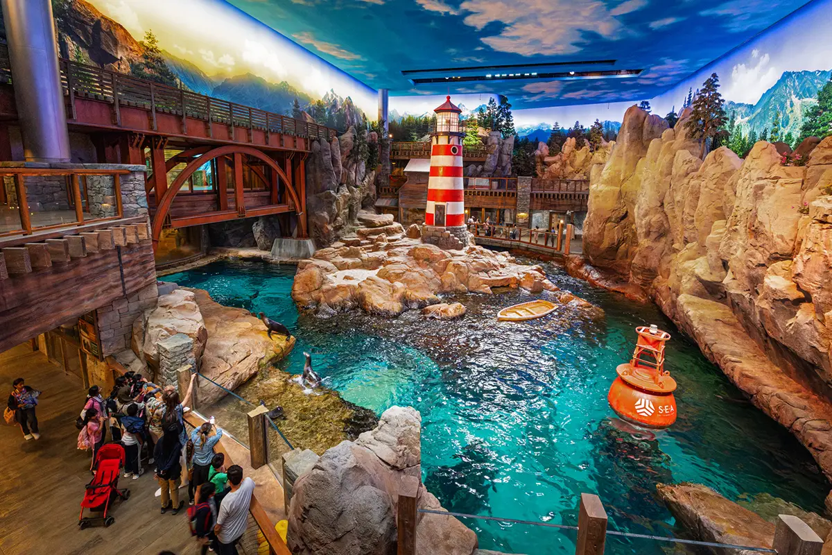 indoor aquarium display with lighthouse