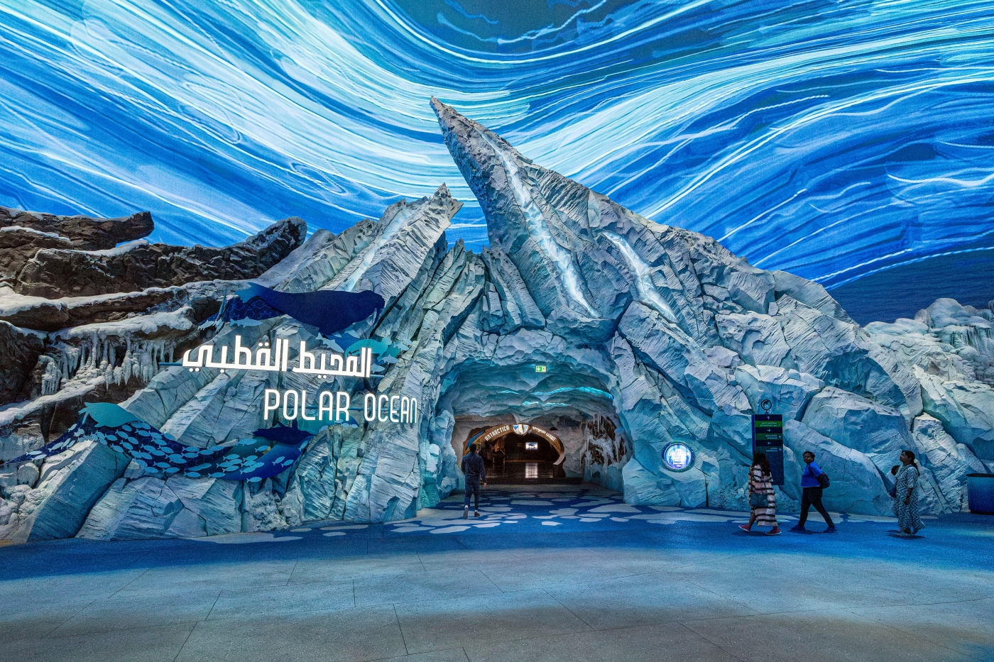 A large visitor portal at SeaWorld Abu Dhabi. Ice and rock form an entryway with the words "Polar Ocean" in English and Arabic protruding from the ice.