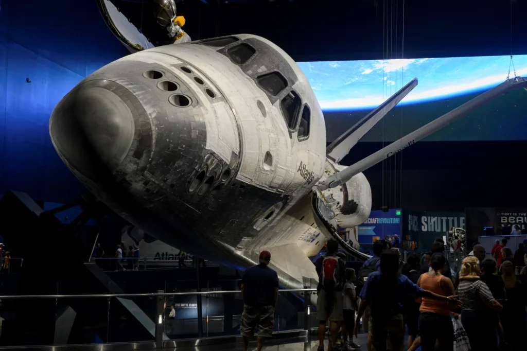 Space Shuttle Atlantis on display at Kennedy Space Center Visitor Complex, with visitors below