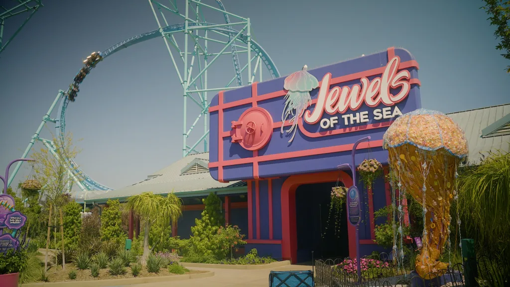Jewels of the Sea entrance at SeaWorld San Diego, framed by palms, succulents and a giant jellyfish sculpture