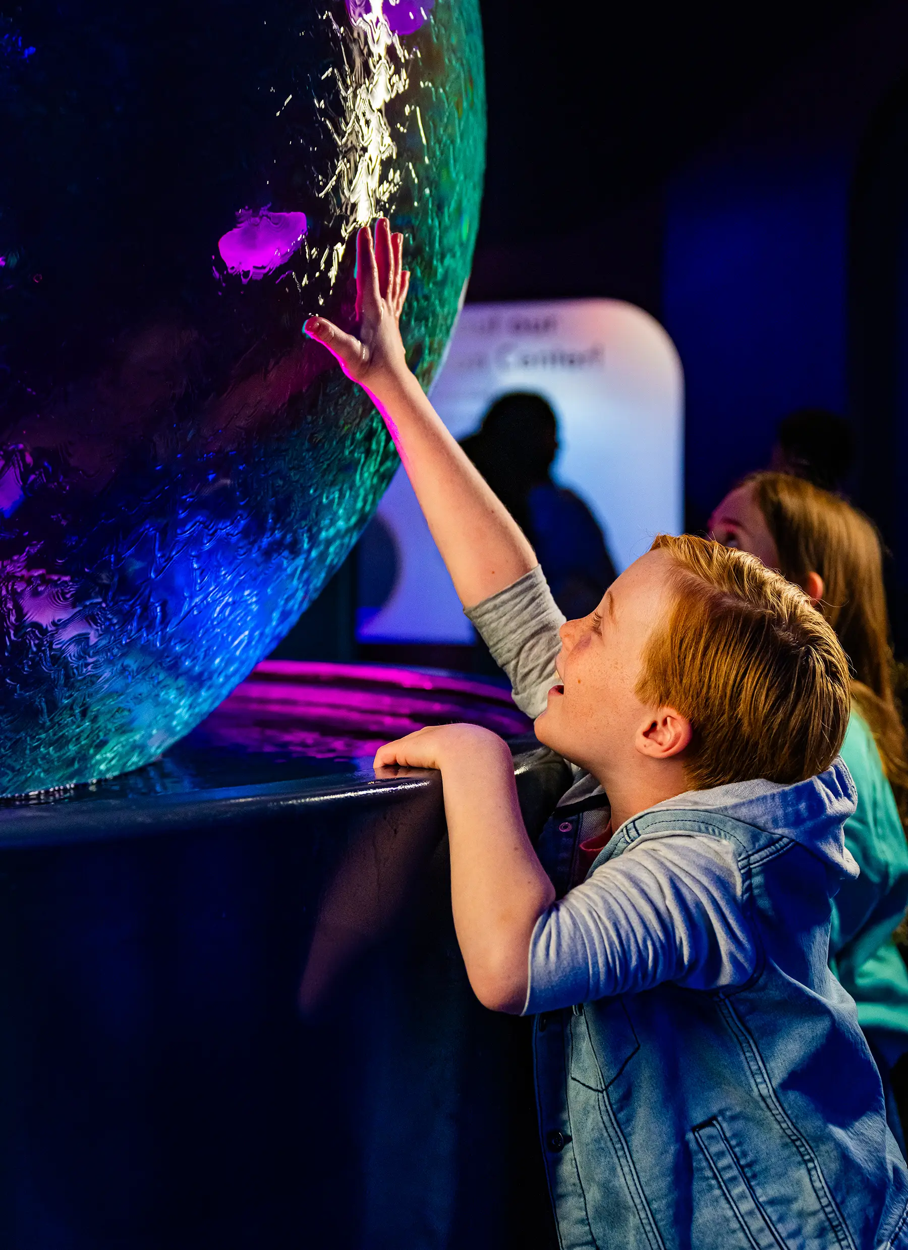 Boy touching jelly fish sculpture at Jellyfish Experience