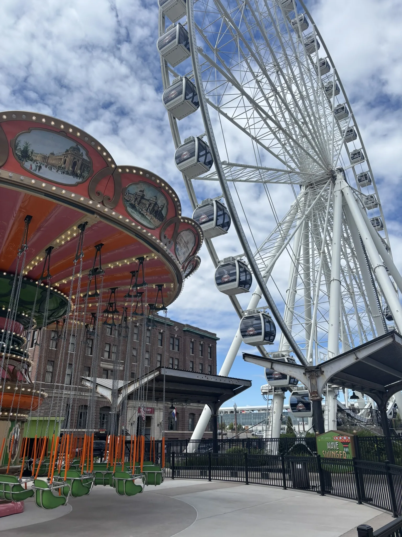 Wave Swinger and the St. Louis Wheel against a blue sky at St. Louis Union Station