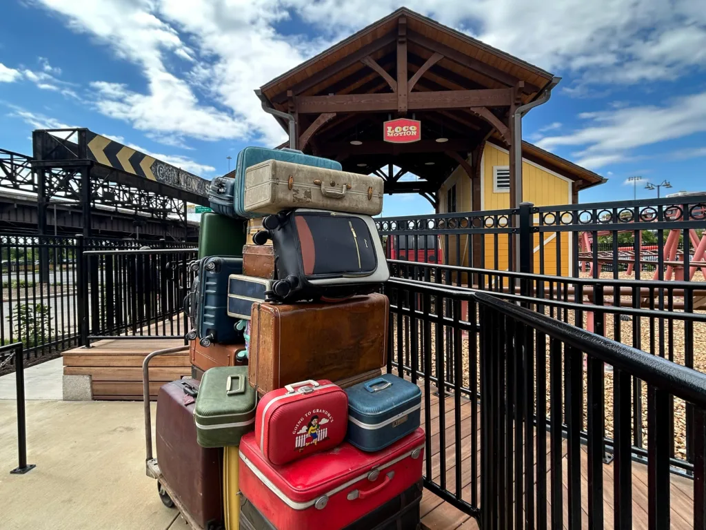 Stack of vintage suitcases at the entrance to the Loco Motion spinning coaster at St. Louis Union Station