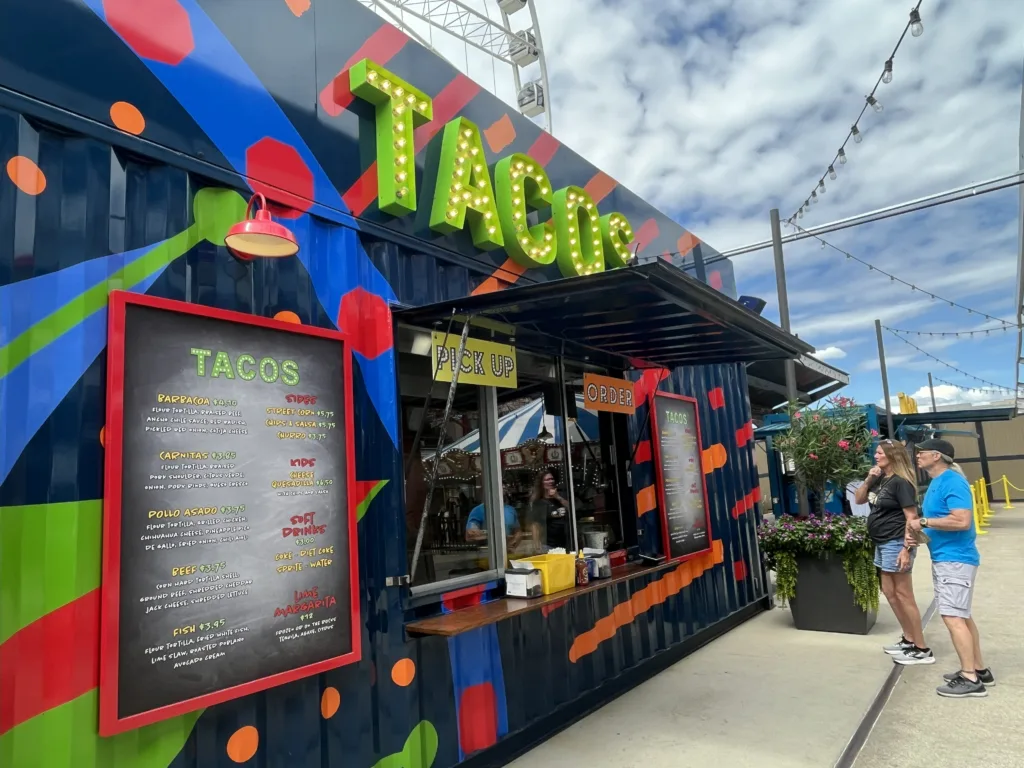 Colorful taco stand built from a shipping container with a marquee sign at St. Louis Union Station