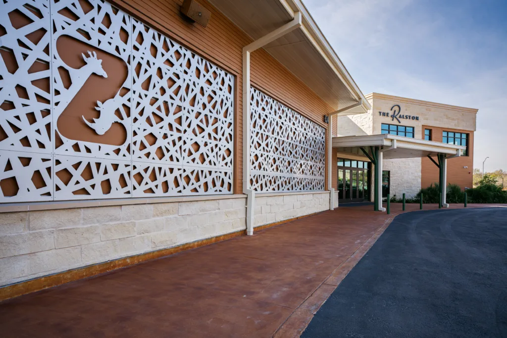 Entrance to The Ralston Event Center at San Antonio Zoo, with a laser-cut giraffe and rhino screen wall